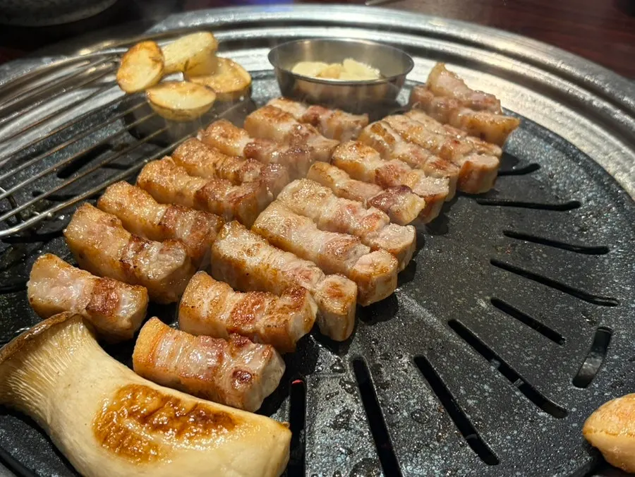 Grill piled high with pork belly