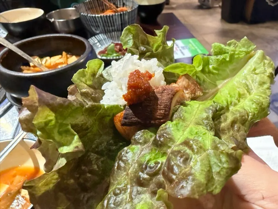 Complimentary bibim guksu topped with vegetables and seaweed flakes