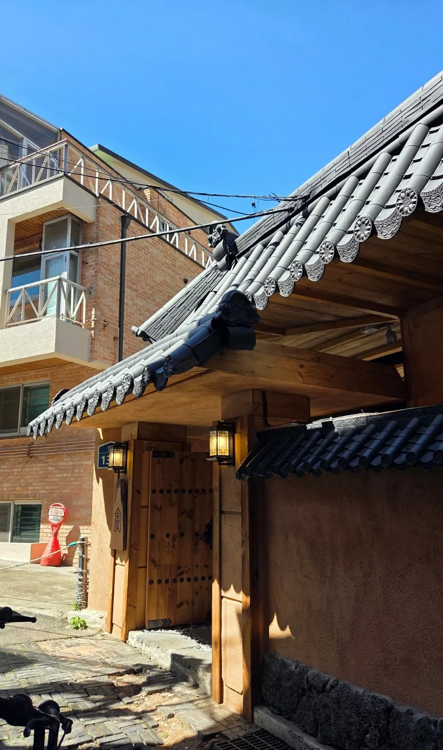 Anok's tiled-roof house and gravel courtyard