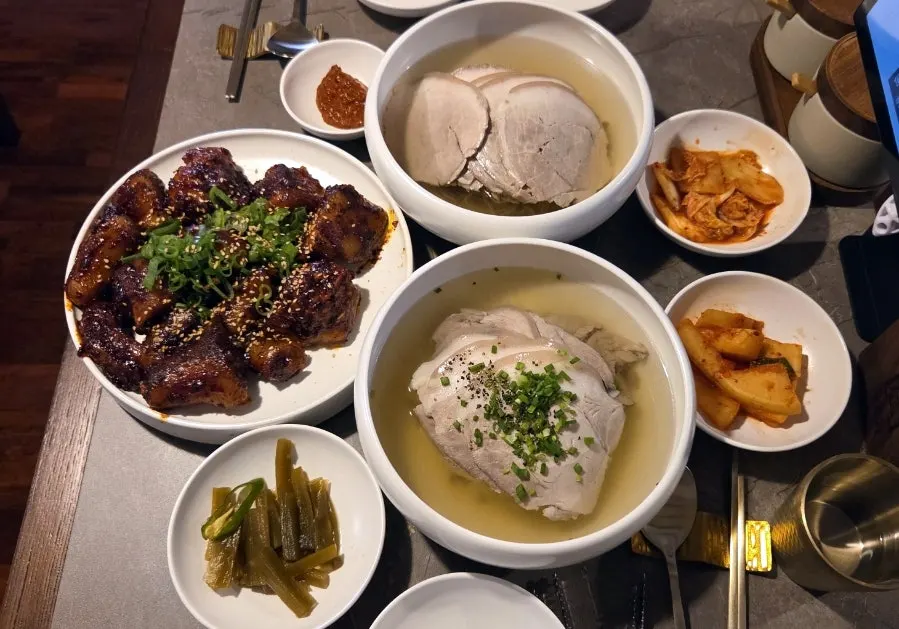 Full spread of gomtang, naengmyeon, and braised pork tails