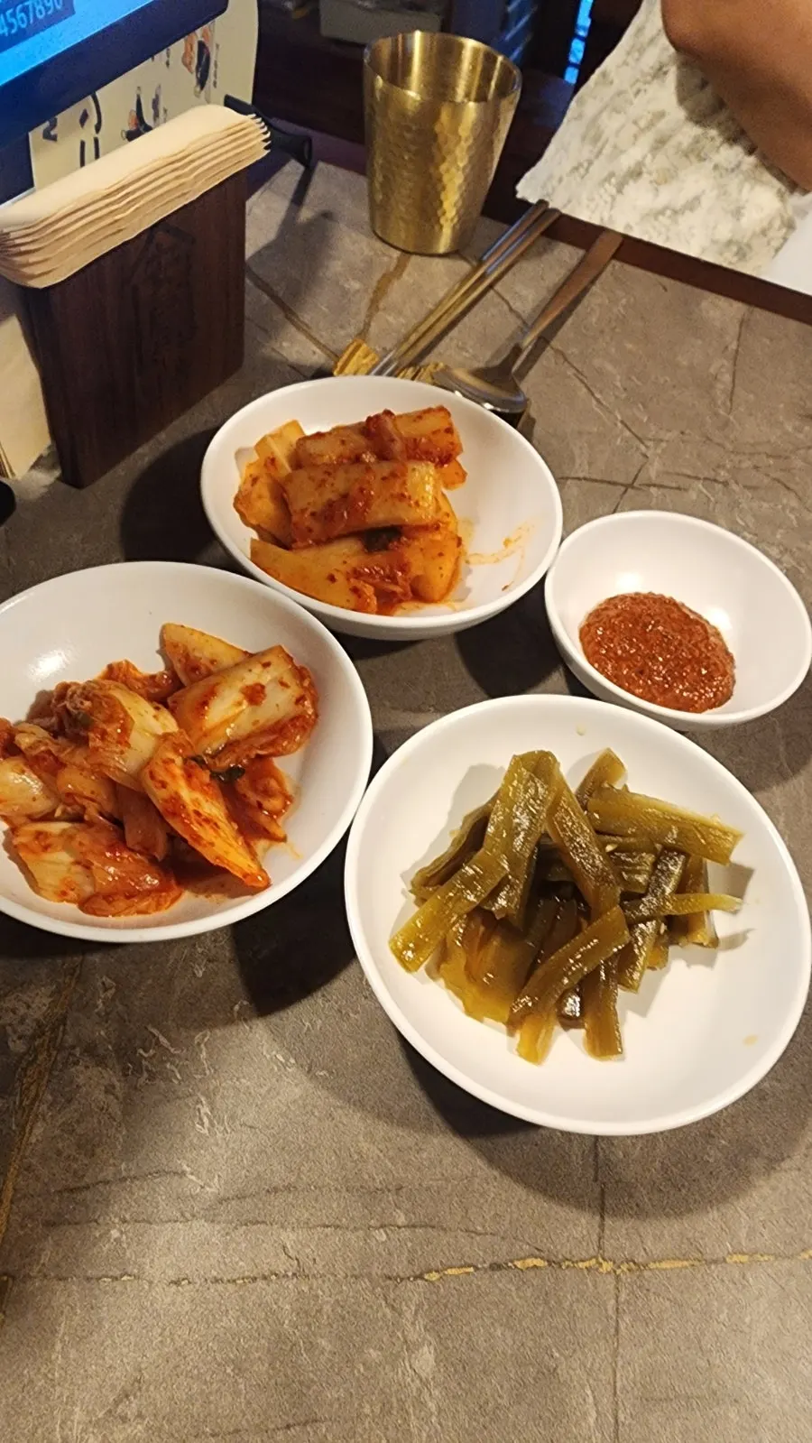 Neatly arranged side dishes with kimchi and gungchae