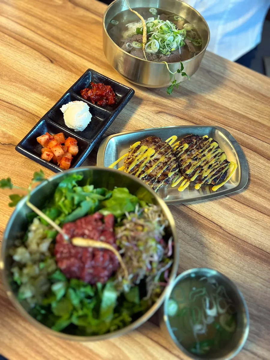 A full spread of gomtang, bibimbap, and tteokgalbi