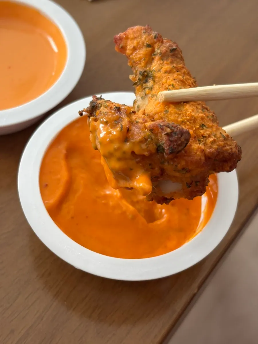 A piece of Gochu Basasak dipped in Goblin sauce