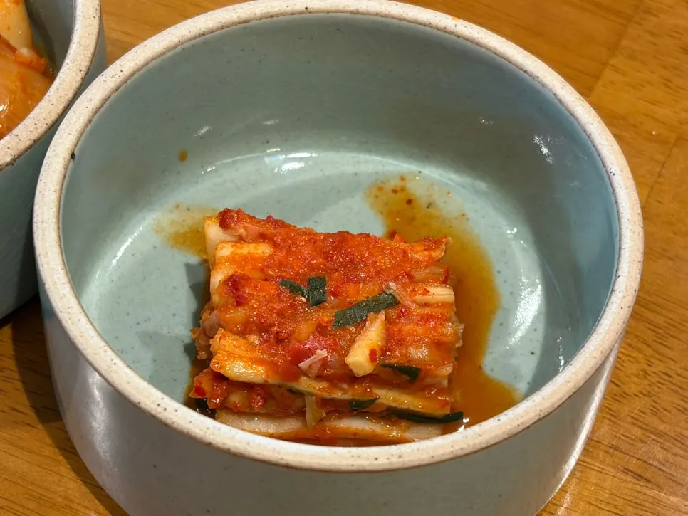 Napa cabbage kimchi served with a lid