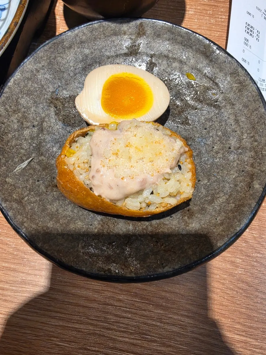 Ramen topped with bean sprouts and soft-boiled egg, with fried shrimp