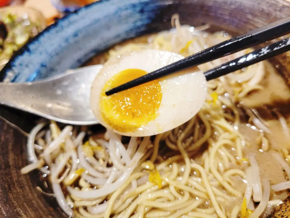 Noodles lifted up from the ramen bowl
