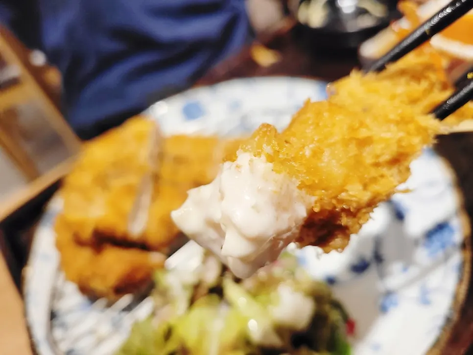 A piece of pork katsu topped with wasabi