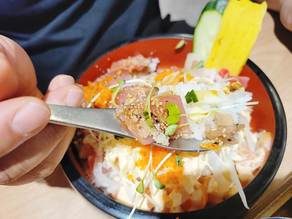 A spoonful of the sushi lifted up