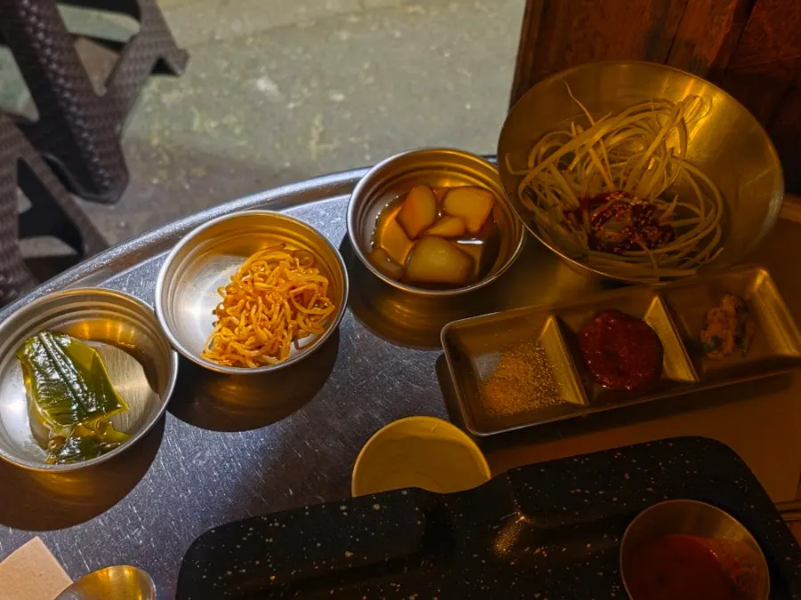 Wrap side dishes including wild garlic leaves and pickled onion
