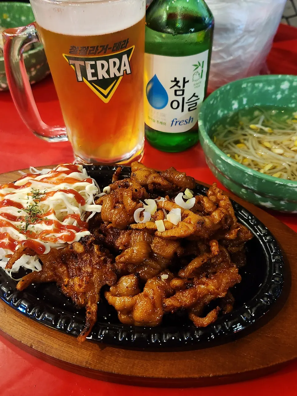 Boneless grilled chicken feet served on an iron plate