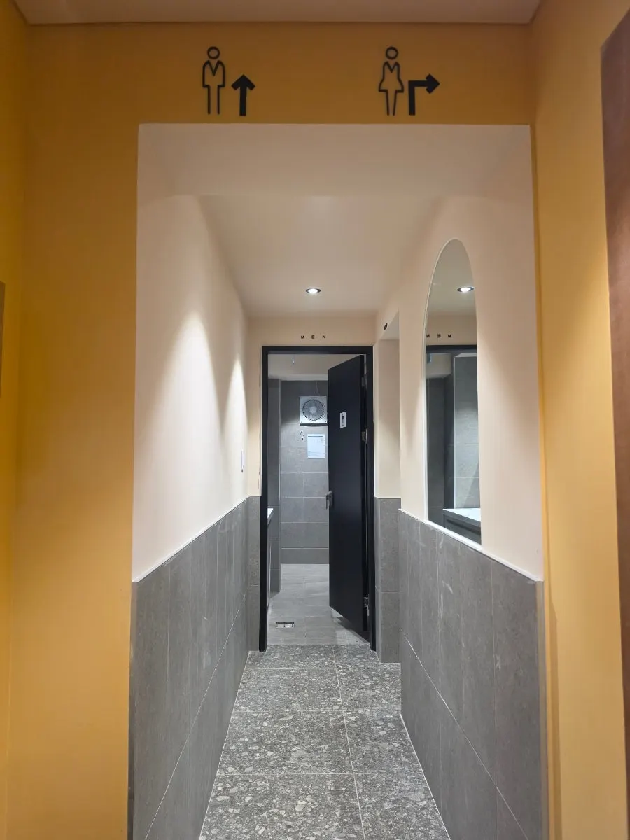 Clean restroom with a sink in each stall