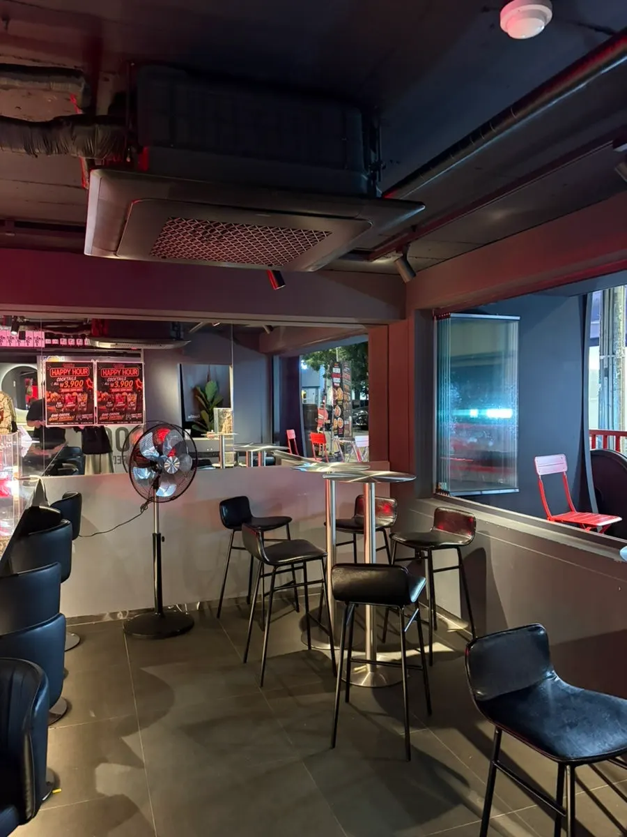 Store space with red lighting and signage