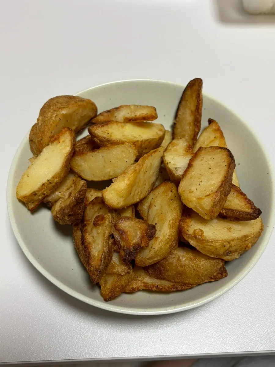 Wedge potatoes transferred into a bowl