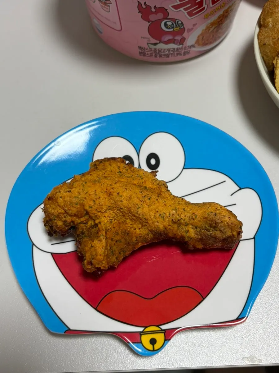 A piece of Gochu Basasak dipped in marbling sauce
