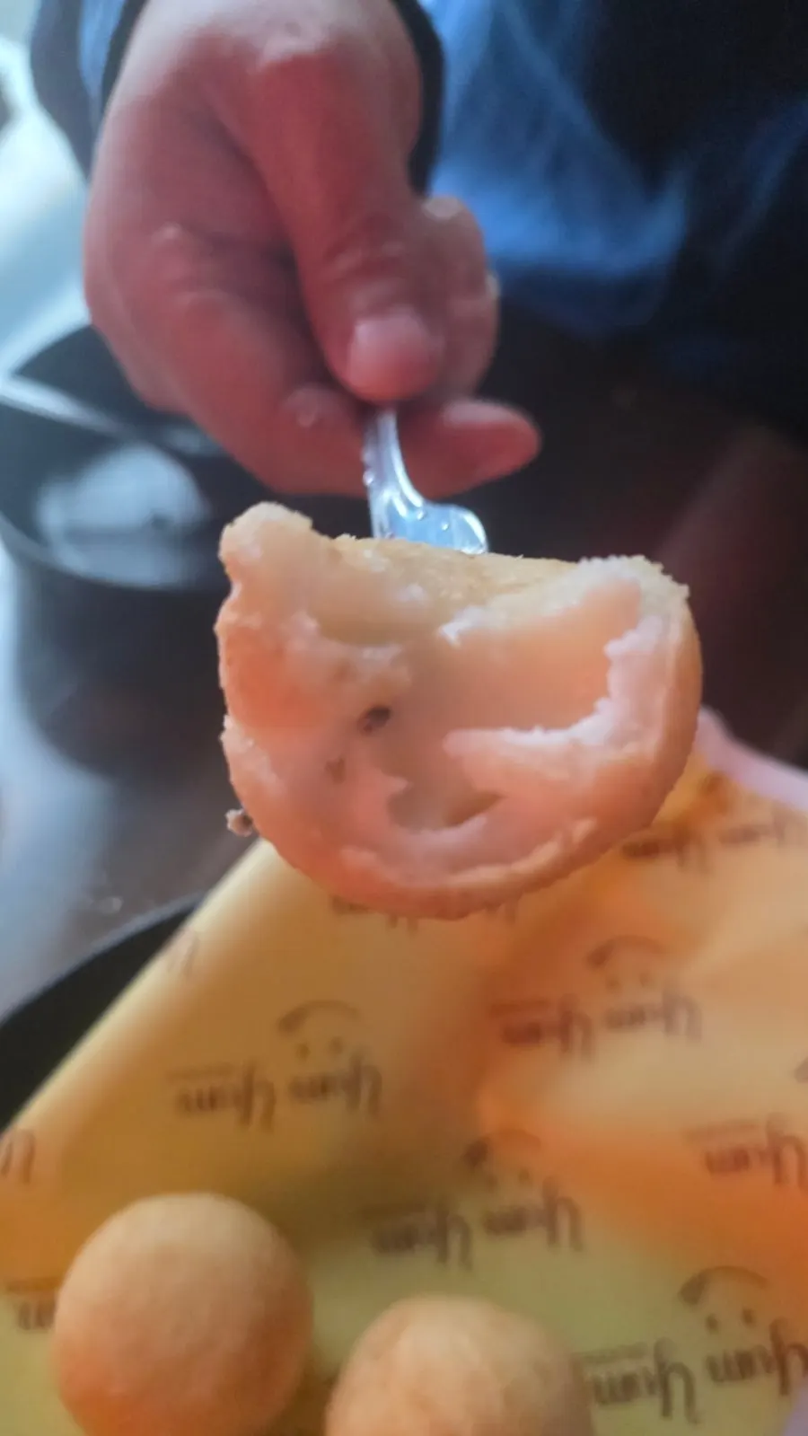 A cheese ball split in half with cheese stretching out
