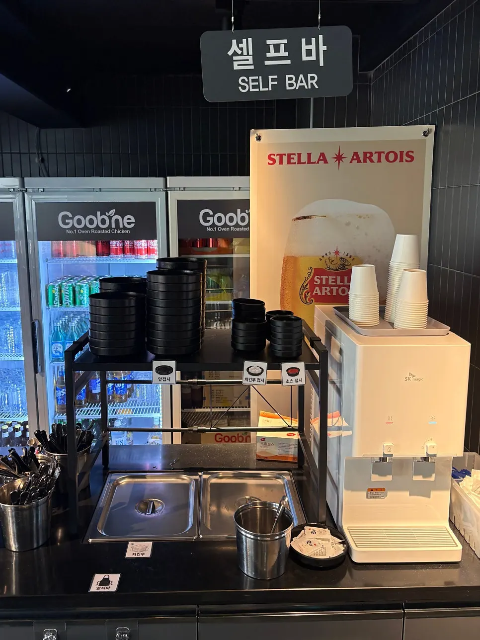 Self-serve bar with water, tableware, and pickled radish