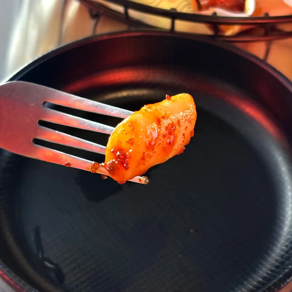 Picking apart the oven-roasted chicken meat with a fork
