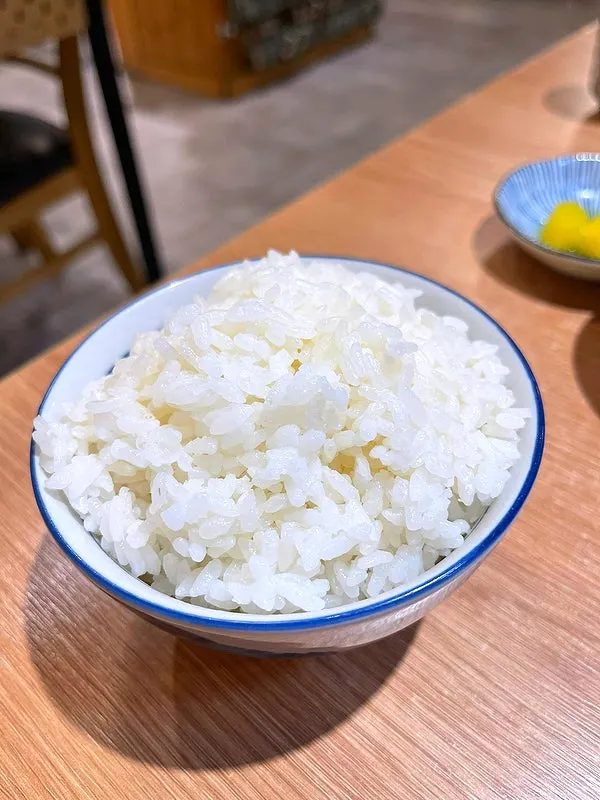 Bowl of ramen broth mixed with rice