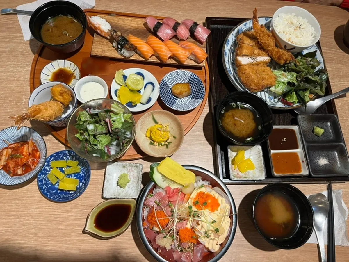 Premium mixed sushi set and pork katsu set together on the table