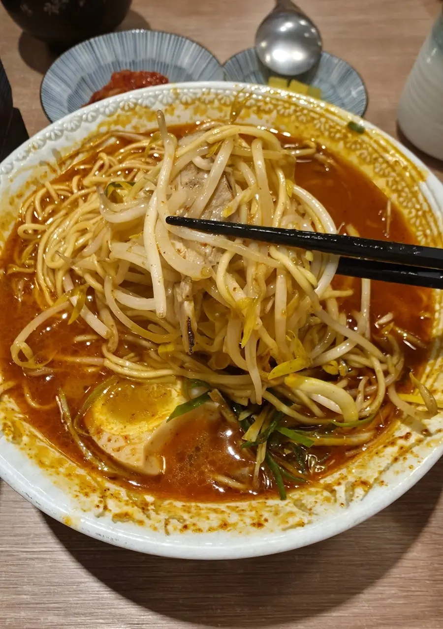 Ramen topped with bean sprouts, scallion and soft-boiled egg