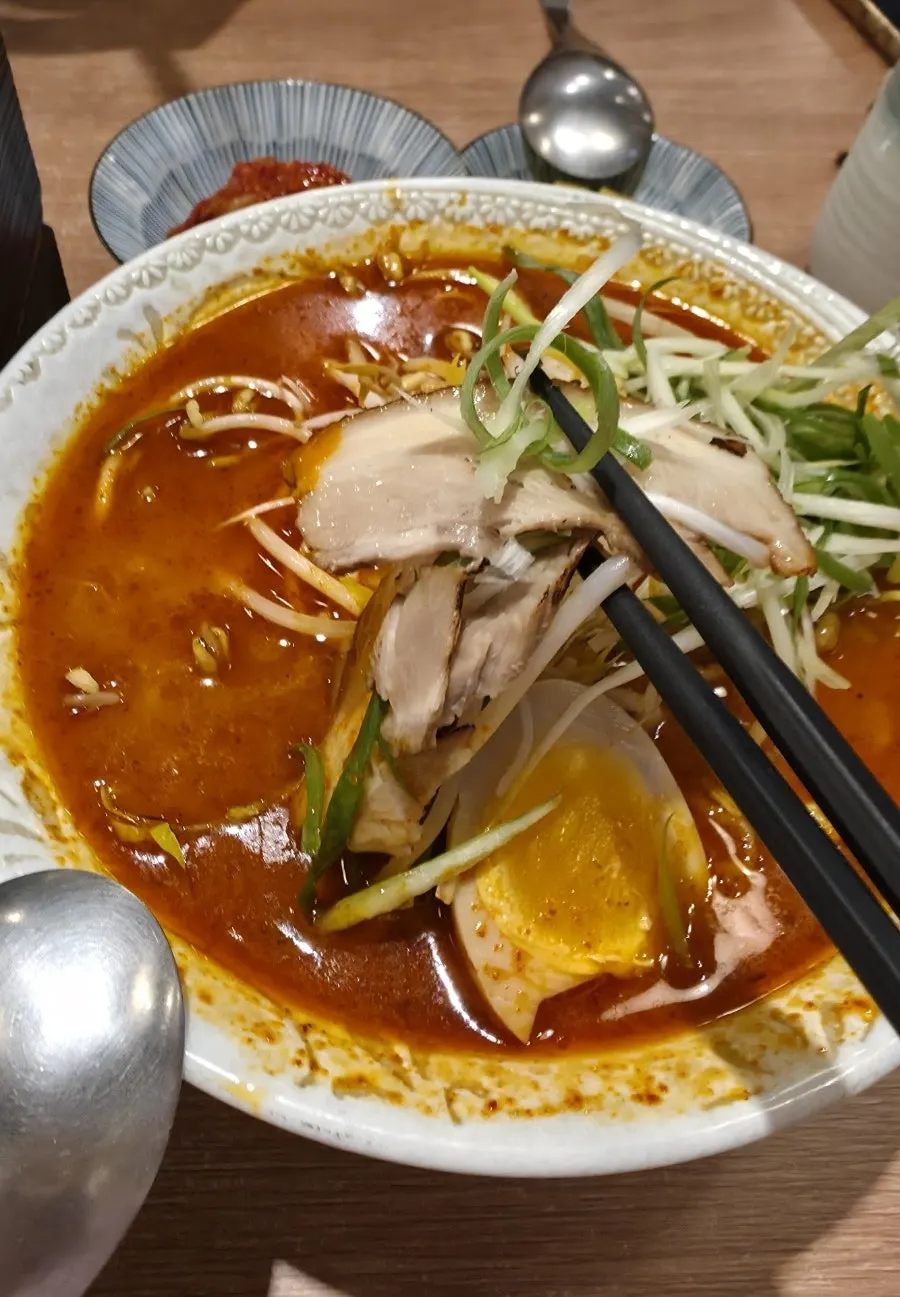 Close-up of spicy ramen noodles and broth