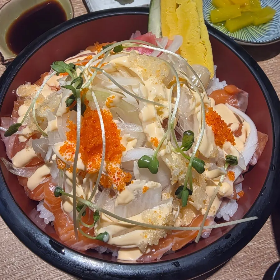 A bowl of chirashi-style salmon sushi