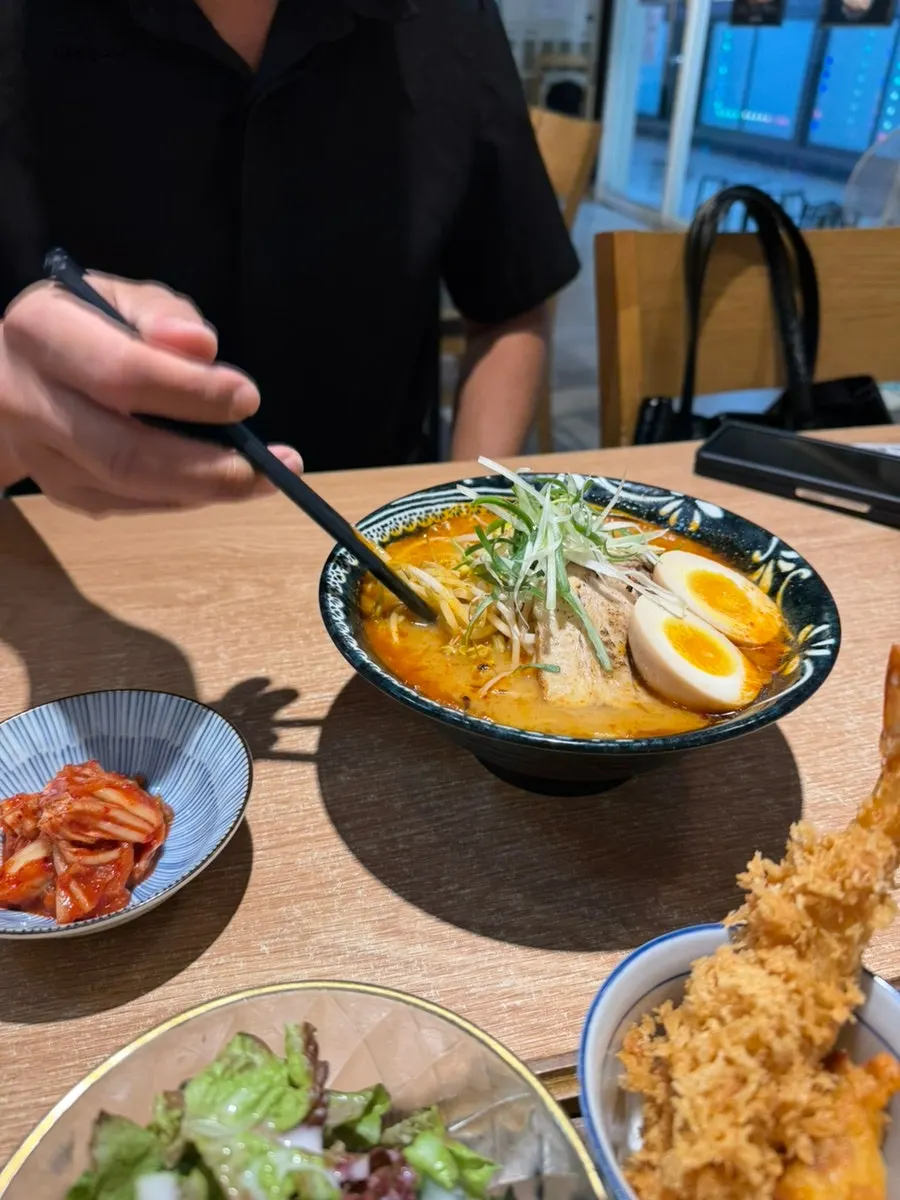 Spicy egg ramen topped with bean sprouts, chashu, and soft-boiled egg