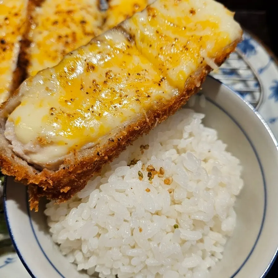 Cross-section of a sliced cheese katsu piece