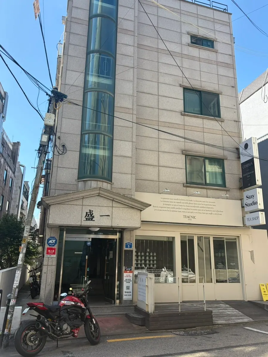 Exterior of the Comma Hair & Makeup building in an alley near Hongdae Station