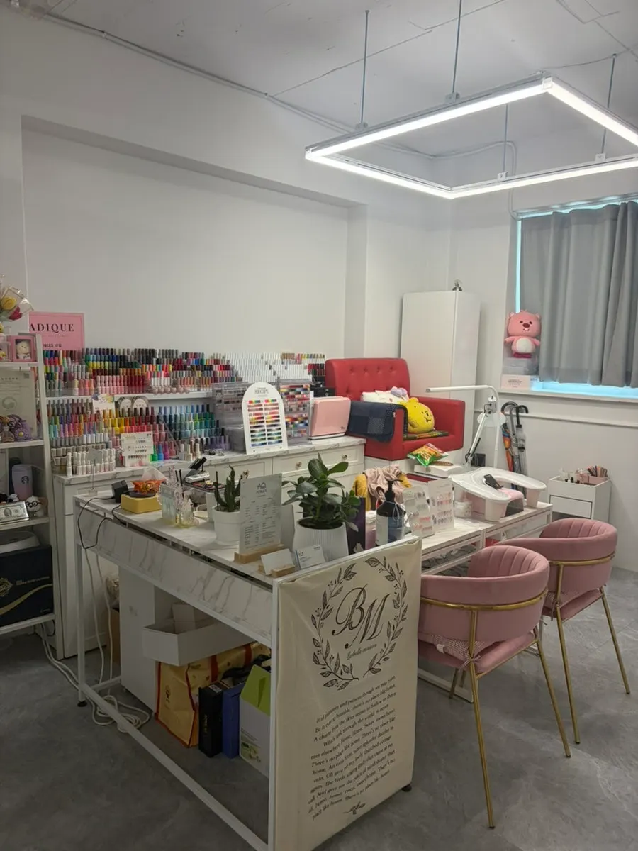 White-toned waiting area inside Comma Hair & Makeup