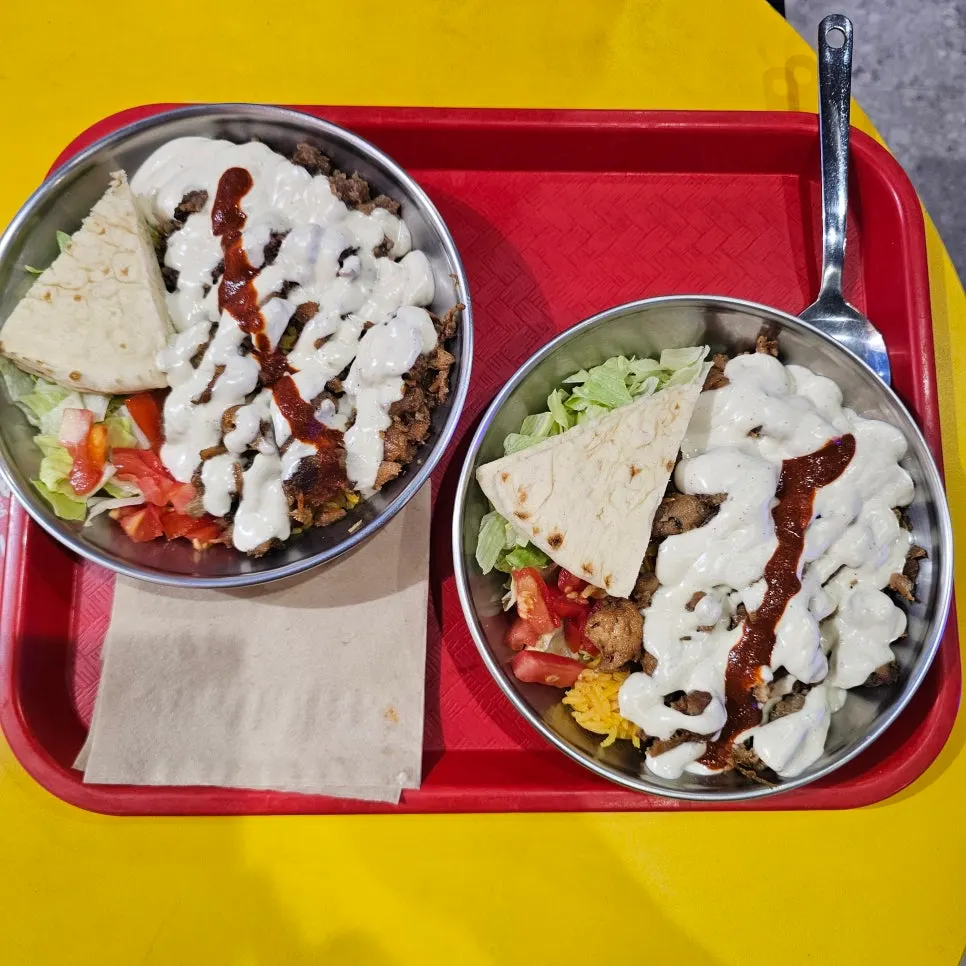 Chicken platter with rice, vegetables, and meat on one plate