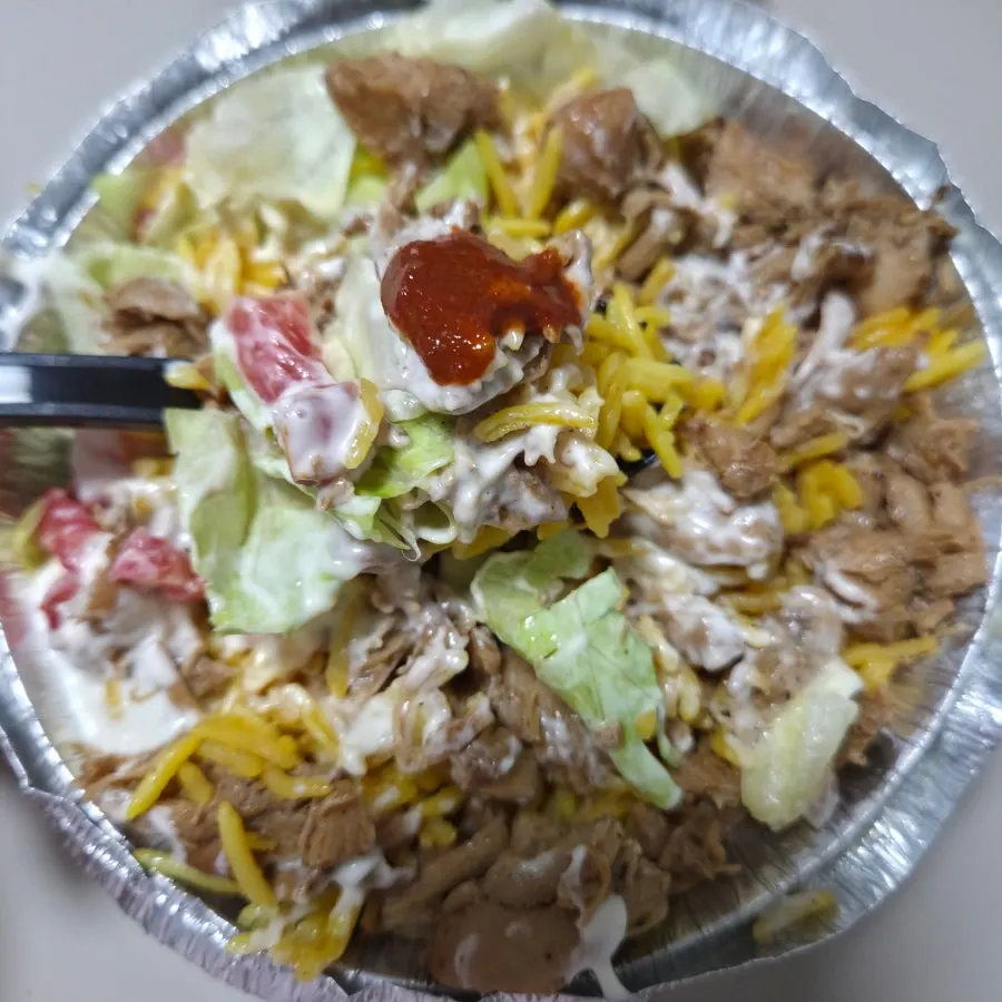 Chicken Platter topped with sauce and hot sauce