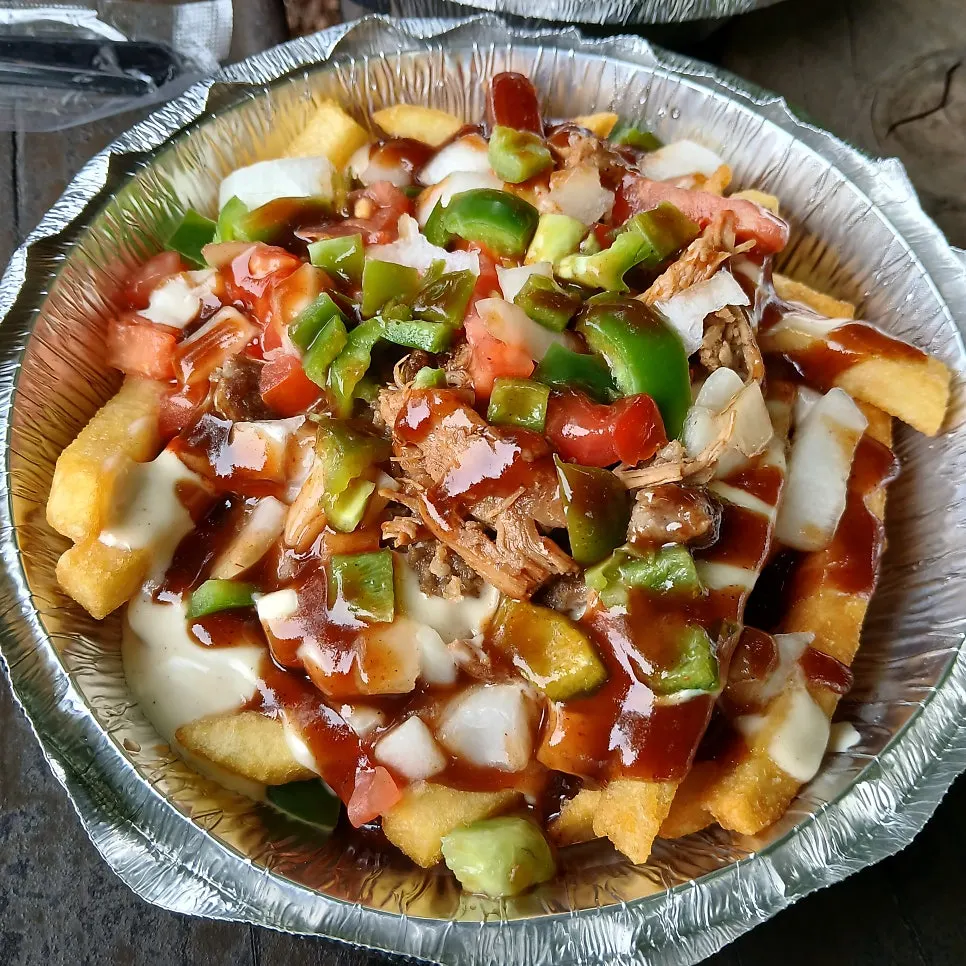 Secret Fries topped with hot sauce