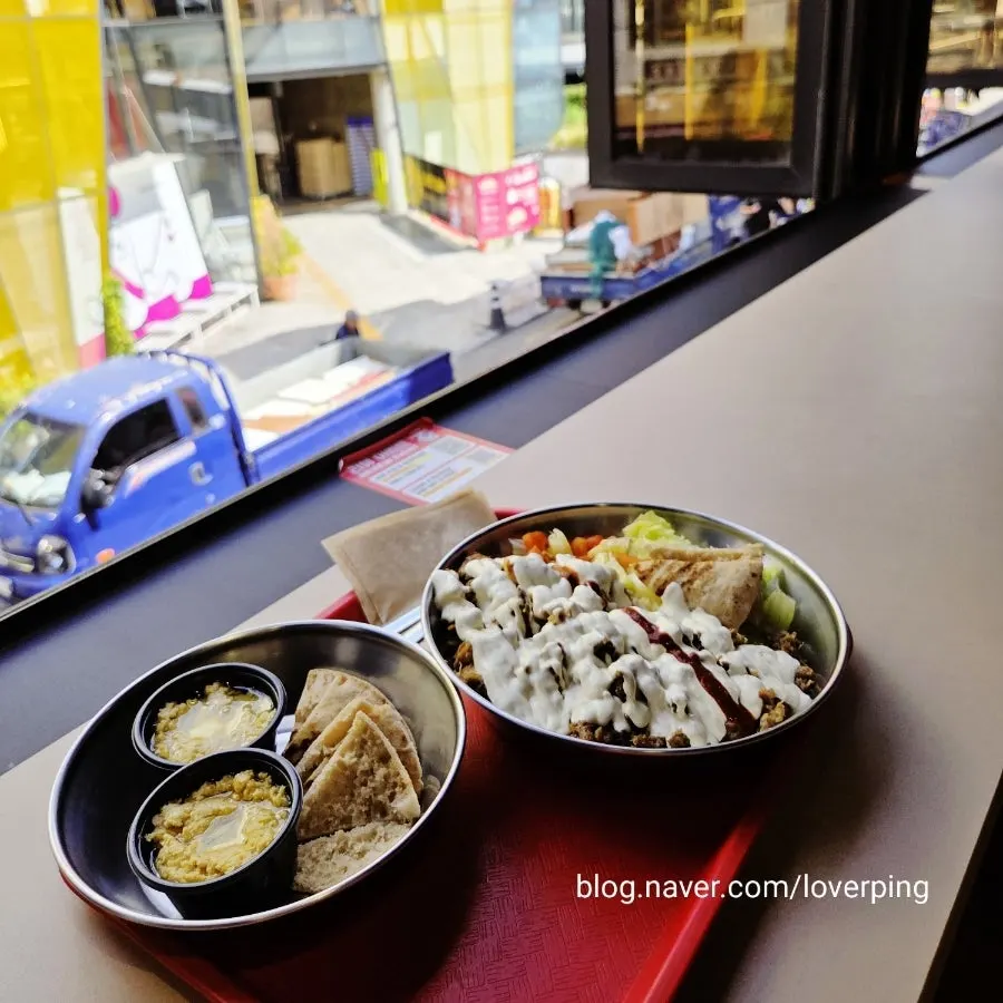 Hummus & bread and combo platter set on the bar table