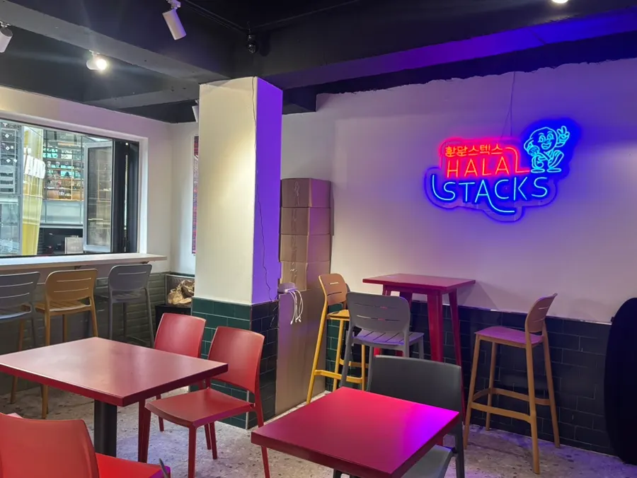 Restaurant interior with a neon logo