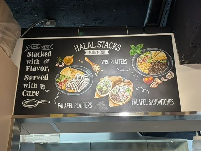 Menu board showing platters and sandwiches at Halal Steaks