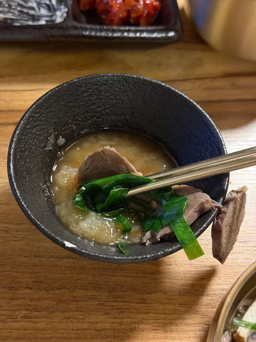 Korean beef cooked in broth ladled over the hot pot