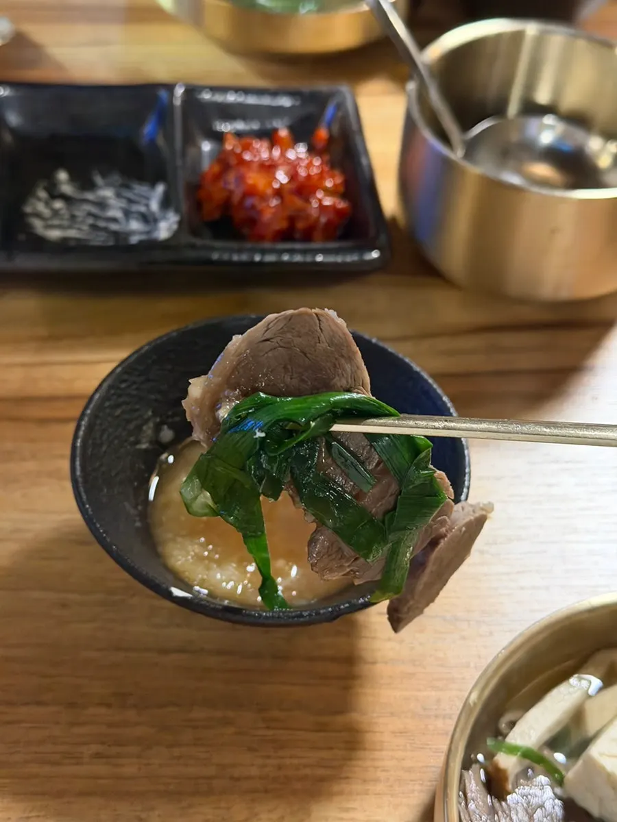 A plate of meat scooped out from the hot pot