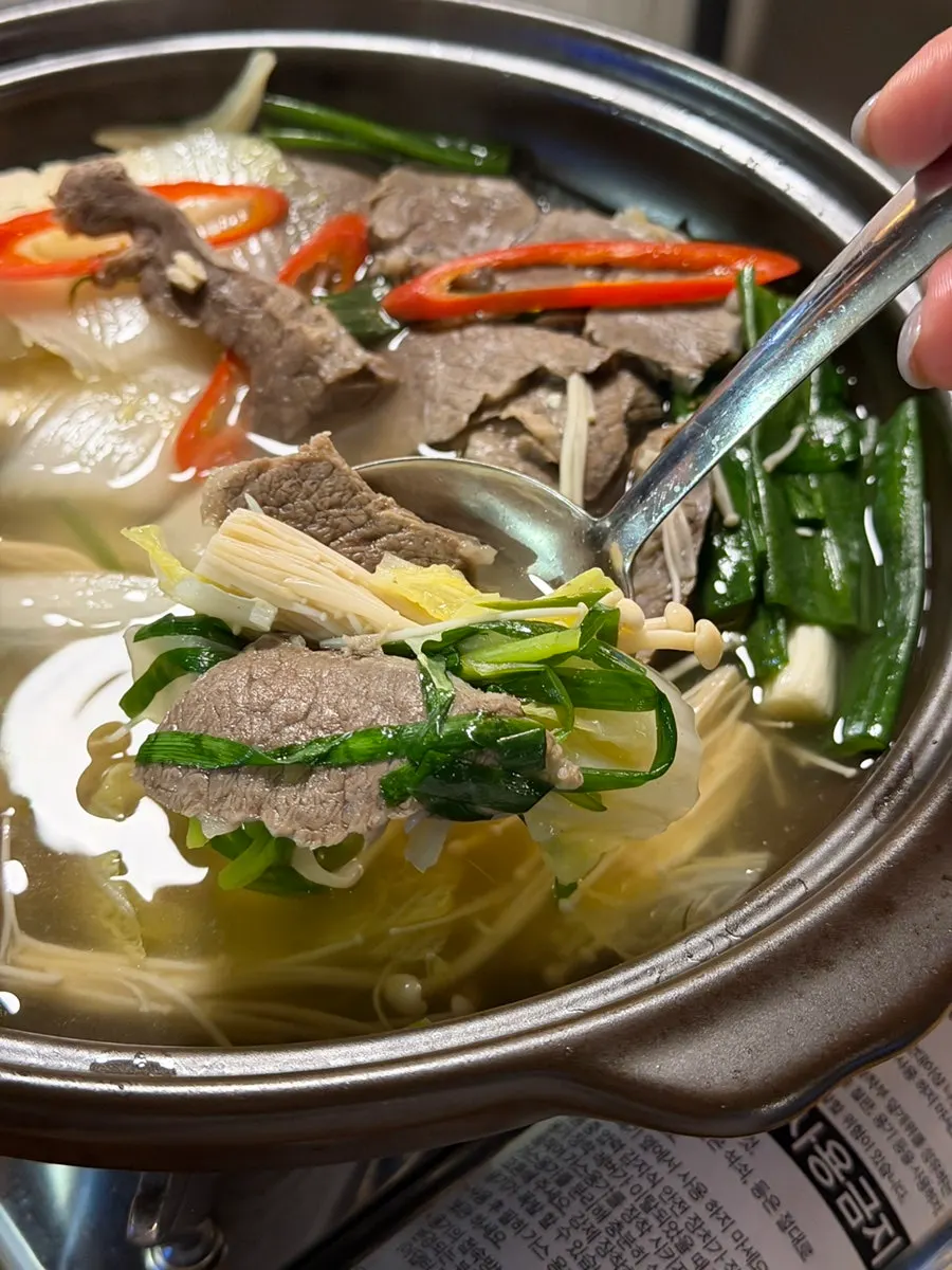 Napa cabbage and enoki mushrooms dipped in special sauce