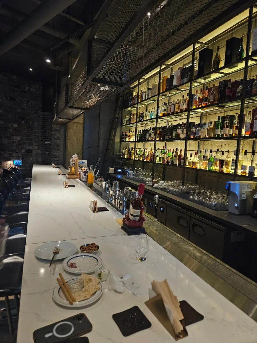 The Bitters bar space beyond the bookshelf door