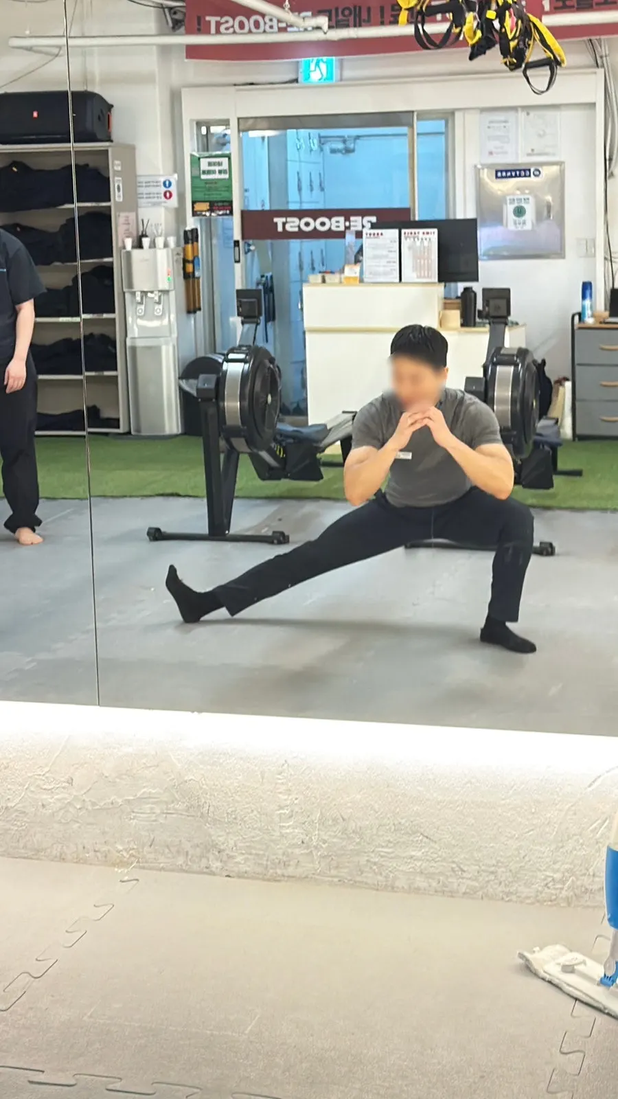 Coach demonstrating a Cossack squat