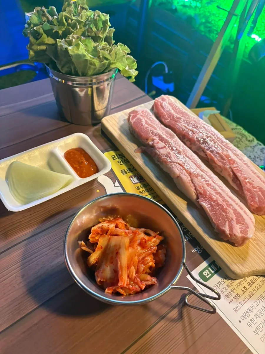 Table setting with two servings of fresh pork belly