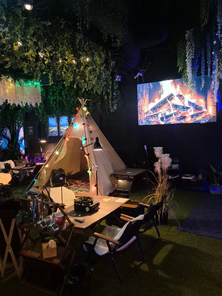 Camping-inspired space decorated with lighting and plants