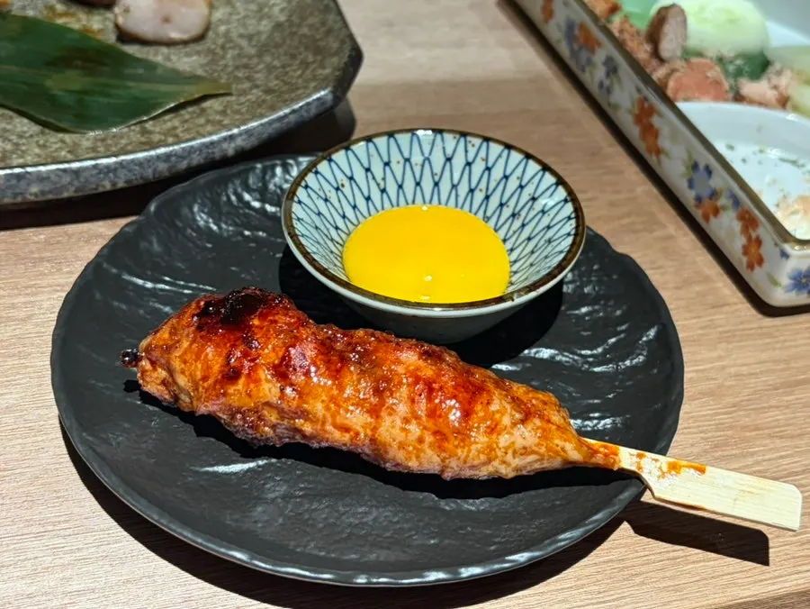 Tsukune skewer served with egg yolk