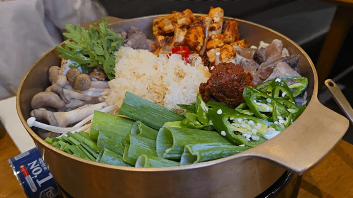 Hanwoo gopchang jeongol and shrimp minari pancake table setting