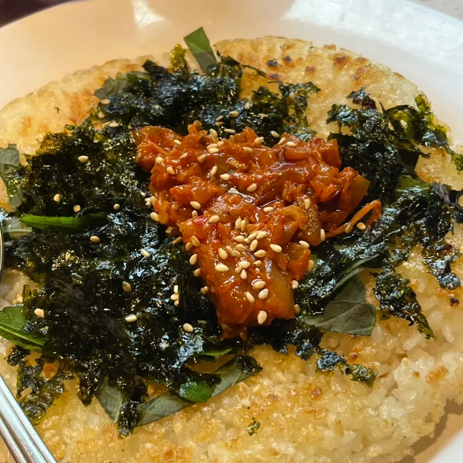 Ongbap crispy rice topped with fried kimchi and seaweed flakes