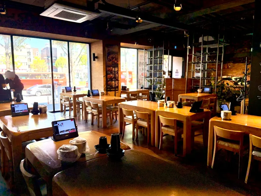 Comfortable jjimdak restaurant hall with floor-to-ceiling windows