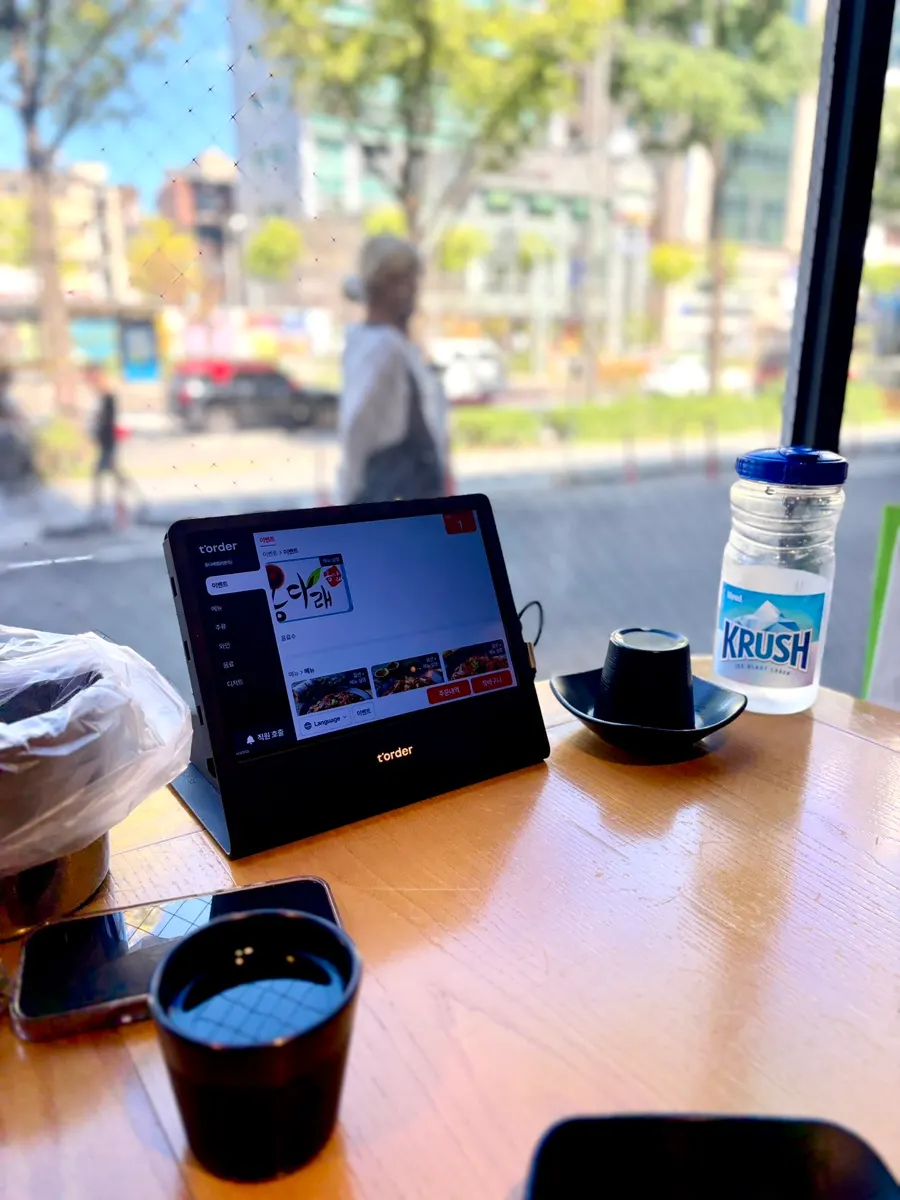 Window-side table with tabletop ordering kiosk