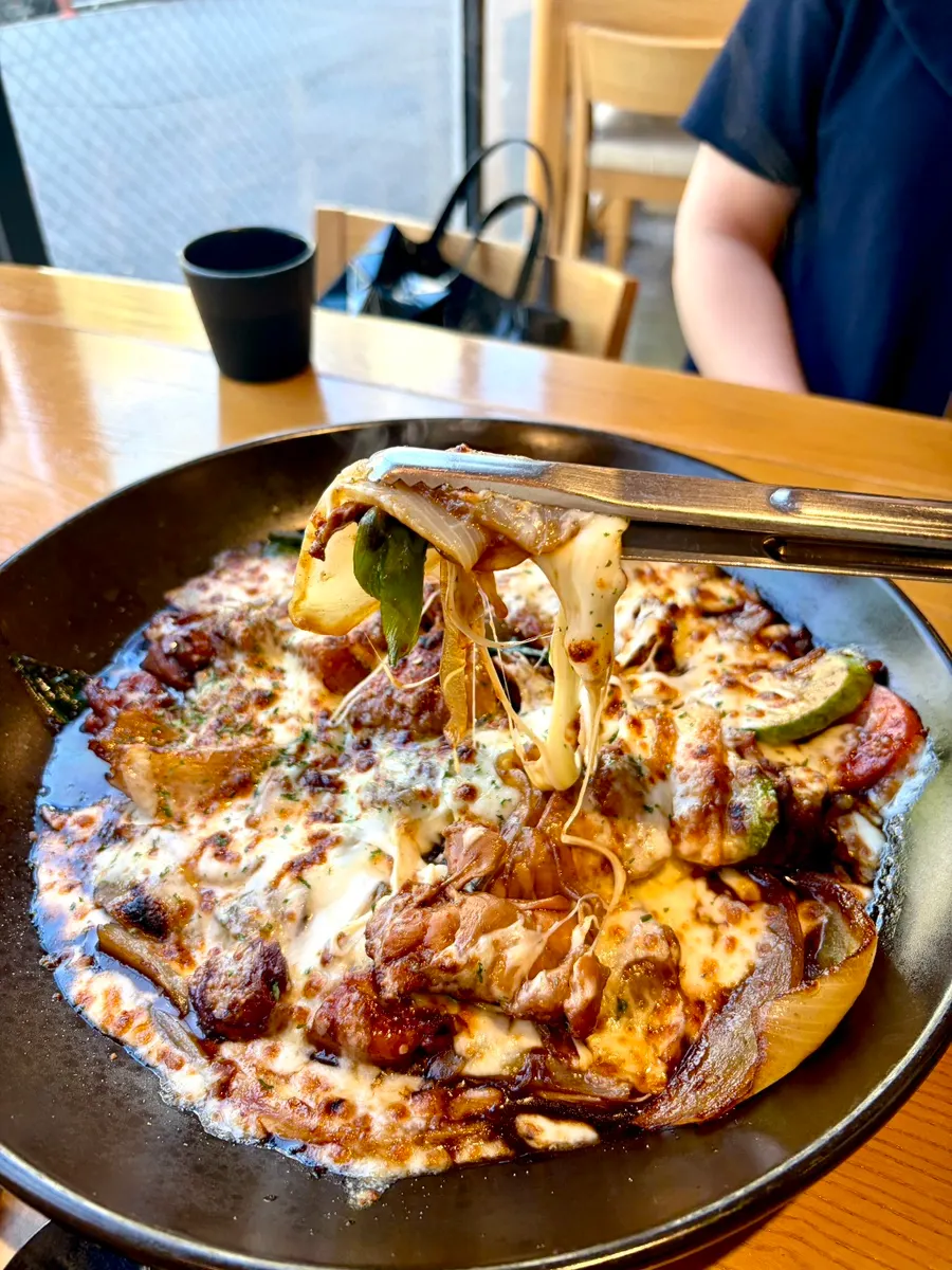 Jjimdak with cheese, glass noodles, sweet potato, and bok choy