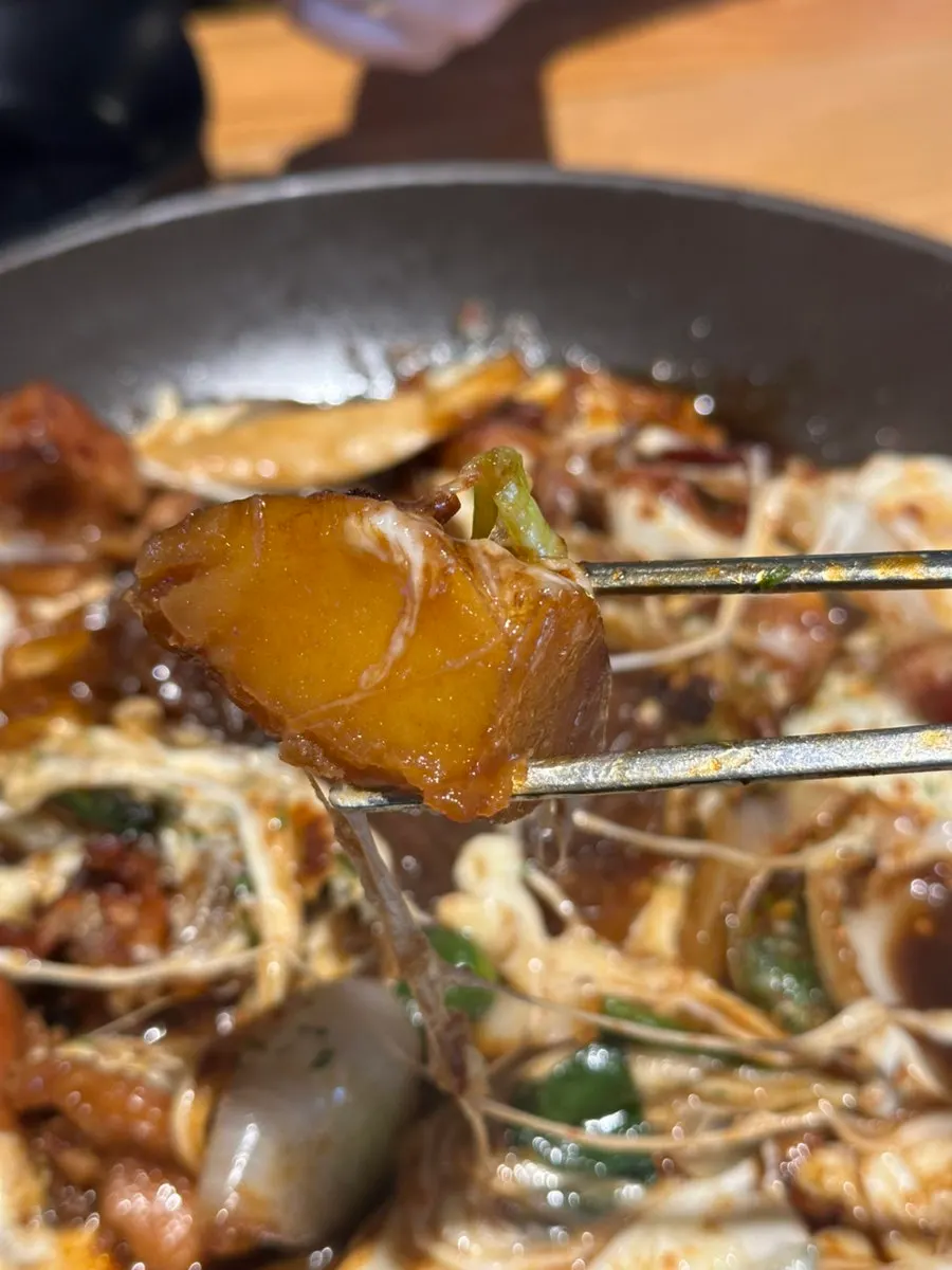 Chicken thigh meat revealed under the cheese